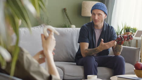 Rear-View-Of-A-Woman-Holding-A-Snake-And-Talking-With-His-Boyfriend-Who-Holding-A-Snake-Too-1