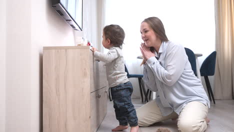 Baby-Sitting-On-The-Floor-Near-The-Dresser-At-Home