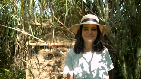 Portrait-of-beautiful-peasant-woman-smiling-with-straw-hat,-closeup