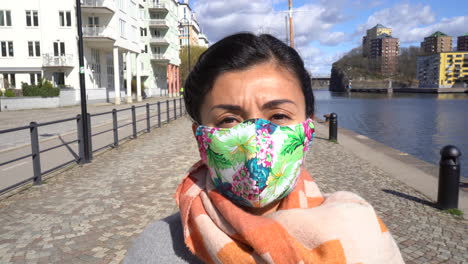 Asian-girl-is-walking-in-the-street-seaside-and-she-is-wearing-a-protective-safety-mask-against-coronavirus-emergency