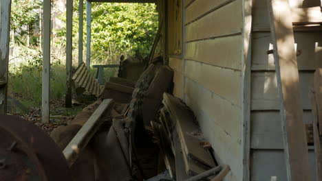 Abandoned-farm-house-with-junk-on-the-front-porch,-TITLT-DOWN