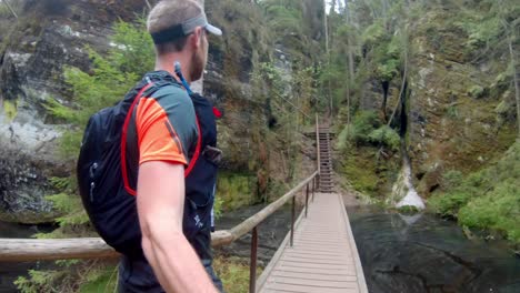 Walking-across-the-stream-in-national-park-Adršpach