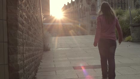 Woman-walks-in-urban-city-sunset