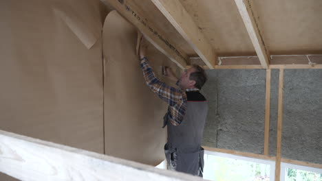 Carpenter-contractor-working-on-insulated-wall,-indoors