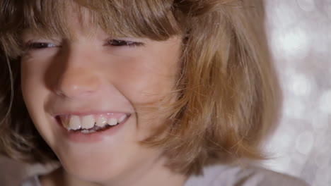 A-cute-little-girl,-looking-at-the-camera-and-smiling,-showing-her-hidden-dental-braces