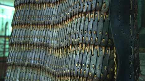 Close-shot-of-an-old-chinese-armor-in-a-museum