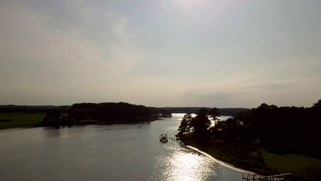 Ascending-while-flying-into-the-sun-towards-the-Chesapeake-Bay-from-Melfa,-VA