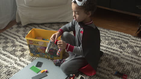 A-small-boy-plays-with-Lego-in-his-home