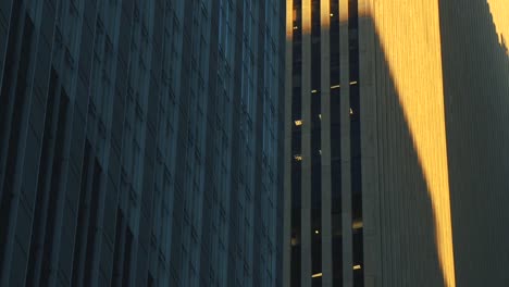 Shadows-on-walls-of-skyscrapers-and-streaks-of-golden-light-from-sunset-over-New-York-City