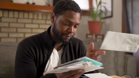 Black-man-tosses-junk-mail-tired-unconcerned-close-up