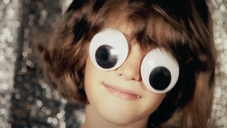 A-little-girl-with-funny-big-googly-eyes,-shaking-her-head