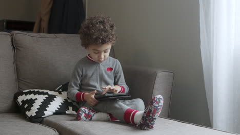 A-small-boy-plays-a-game-on-a-tablet-2