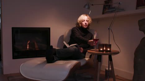 A-woman-sitting-by-the-fireplace-reading-a-book