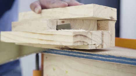 Close-up-detail-shot-of-saw-teeth-cutting-through-wood-on-a-workbench-manual-labor-woodworking-tool