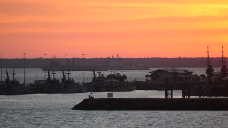 Naval-Dockyard-HMAS-Coonawarra,-International-Naval-vessels-visible-in-harbor-and-background