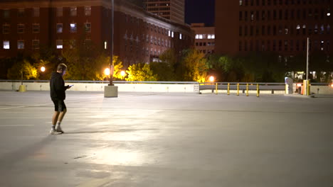 4K-footage-of-person-walking-across-a-parking-lot-while-looking-at-their-phone