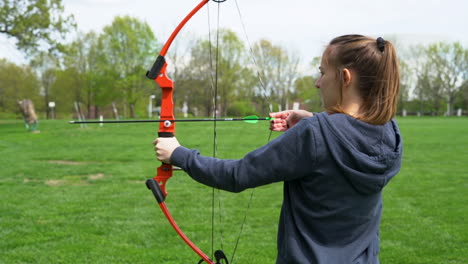 HD-footage-of-girl-shooting-a-bow-and-arrow-at-an-archery-range-in-slow-motion