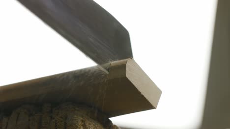 Sharp-saw-teeth-cutting-into-batten-end-piece-and-cutting-it-off