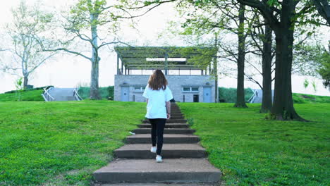 Nice-footage-of-girls-walking-up-steps-at-a-park