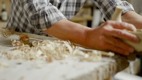 Artisan-pulls-and-pushes-hand-plane-over-batten-to-make-it-thinner