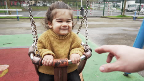 Gimbal-shot-of-baby-playing-on-swing-with-social-distance