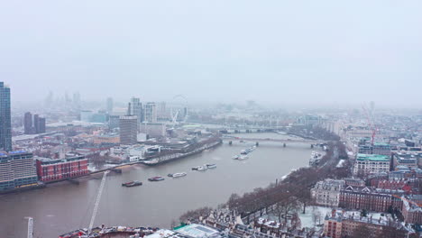 London-snow-aerial-drone-slider-shot-south-bank-waterloo-bridge-london-eye
