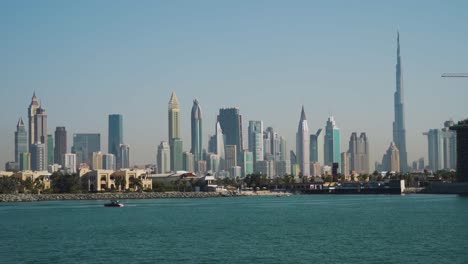 Boat-Cruising-At-Persian-Gulf-With-Burj-Khalifa-And-Dubai-Skyline-At-Dubai,-UAE,-Middle-East