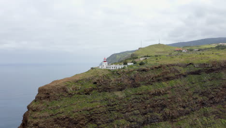 Drone-aerial-footage-of-Ponta-do-Pargo-Lighthouse-on-the-west-side-of-Madeira-island,-Portugal-on-huge-cliffs