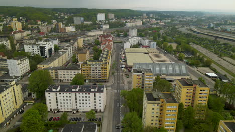 Dolly-aerial-drone-shot-of-Gdynia-Poland-city-buildings-along-main-road