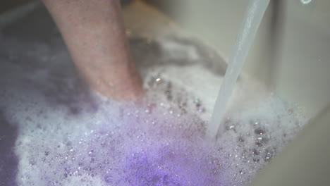 Filling-up-a-foot-bath-with-water-and-bubbles-in-a-paediatric-clinic-2