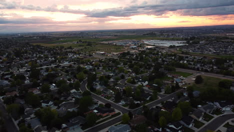 Aerial-landscape-view-over-a-suburban-green-area,-at-sunset