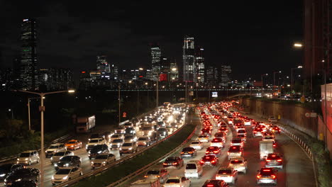 Traffic-jam-in-Seoul,-South-Korea-at-night-on-major-highway,-Gangbyeonbuk-ro