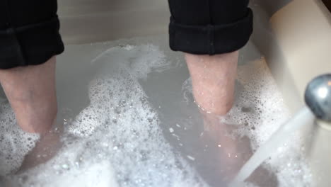 Filling-up-a-foot-bath-with-water-and-bubbles-in-a-paediatric-clinic