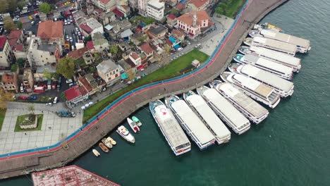 Aerial-view-of-ferry-boats-docked-at-a-port-on-the-Bosphorus-River-in-Karakoy-Istanbul-Turkey-on-a-cloudy-day