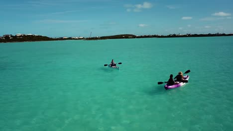 Tourists-riding-a-boat-in-the-open,-clear,-and-shallow-water-of-Turks-And-Caicos,-Atlantic,-North-America-4K-UHD