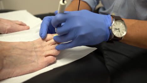 Woman-getting-a-laser-treatment-for-her-feet-in-a-paediatric-clinic