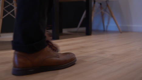 Person-walking-with-brown-shoes-in-a-paediatric-clinic