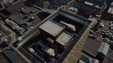 4K-60-FPS-Birdseye-Aerial-drone-flight-over-Manchester-Arndale-Tower-with-retail-buildings-rooftops-below