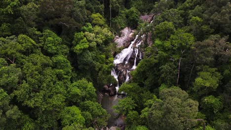 Drone-aerial-camera-shot-travelling-across-the-evergreen-Thai-mountains,-waterfalls,-and-rainforests,-including-Koh-Phangan-Island-and-the-Than-Sadet-waterfall-area