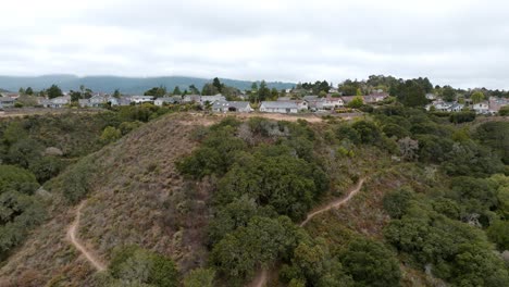 Drone-Flying-Towards-Unique-Cottages-Design-In-Village-Located-Top-View-Mountain,-San-Mateo