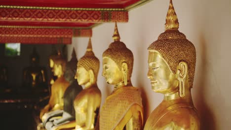 Close-Up-Gold-Leaf-Buddha-Statues-in-Bangkok,-Thailand-at-Buddhist-Temple,-Buddhist-Statues-Portraits-and-Details-of-Faces-and-Heads-at-Wat-Pho-,-Southeast-Asia-1