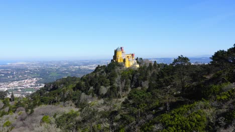 Aerial-Drone-View-of-Pena-Palace,-Sintra,-Lisbon,-Portugal,-and-the-beautiful-forest-and-mountain-landscape,-UNESCO-World-Heritage-Site-Architecture-and-Popular-Tourist-Attraction,-Europe-2