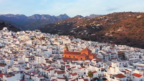 Aerial-Drone-View-of-Church-in-Spanish-Town-in-Torrox,-Spain,-Costa-Del-Sol-Mountains,-Andalusia-,-Europe,-White-Buildings-and-Houses-Popular-in-Property-Real-Estate-Housing-Market