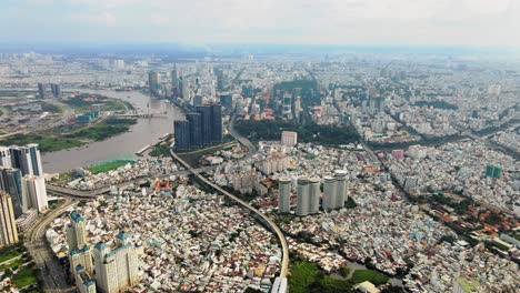 Aerial-tilt-down-view-of-heavily-developed-Ho-Chi-Minh-City,-Vietnam