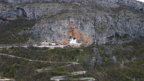 Aerial-drone-view-of-Ostrog-monastery-in-vertical-rocky-mountain-is-the-most-popular-pilgrimage-place-in-Montenegro-1