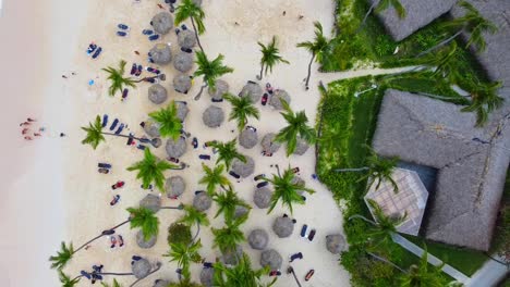 A-drone-aerial-shot-of-the-beach-at-Dominican-republic-at-a-resort-of-everyone-relaxing-on-chairs