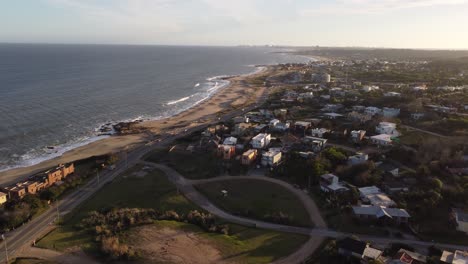 Aerial-flyover-coastal-city-and-Punta-del-Este-Beach-at-golden-sunset-in-Uruguay