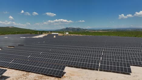 Aerial-view-low-over-a-photovoltaic-energy-farm,-built-on-sand,-in-Eastern-Europe