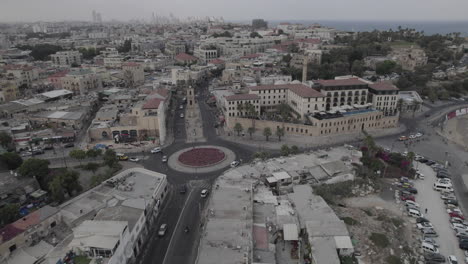 Aerial-view-at-sunrise-over-the-city-of-Jaffa-in-Israel,-passing-over-the-main-square-of-Jaffa-and-the-ancient-clock-tower-of-the-city-2