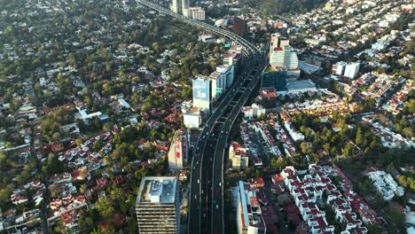 Highway-Interstate-through-Downtown-Buildings-of-Mexico-City,-Aerial-View-from-Above